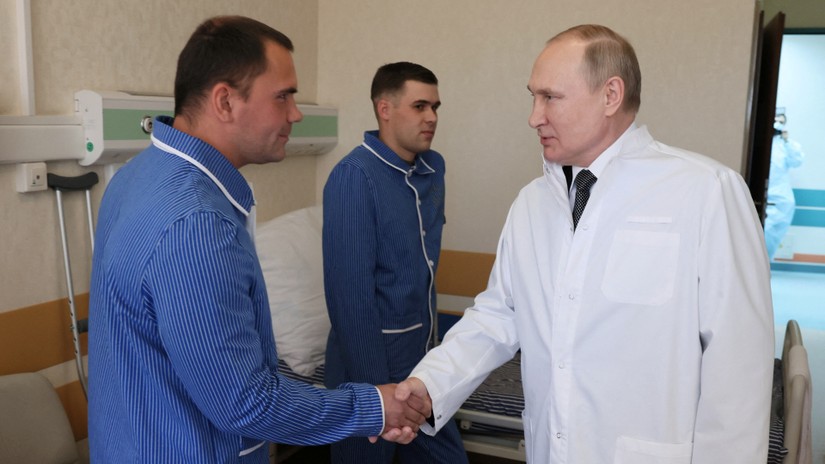 Tổng thống Putin bắt tay một thương binh trong bệnh viện quân y ở Moscow, Nga. Ảnh: Reuters