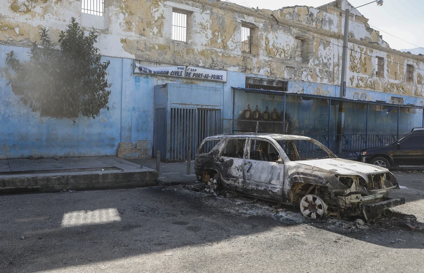 Một chiếc ô tô bị cháy bên ngoài Nhà tù Quốc gia ở Port-au-Prince, Haiti ngày 3/3/2024. Ảnh: AP